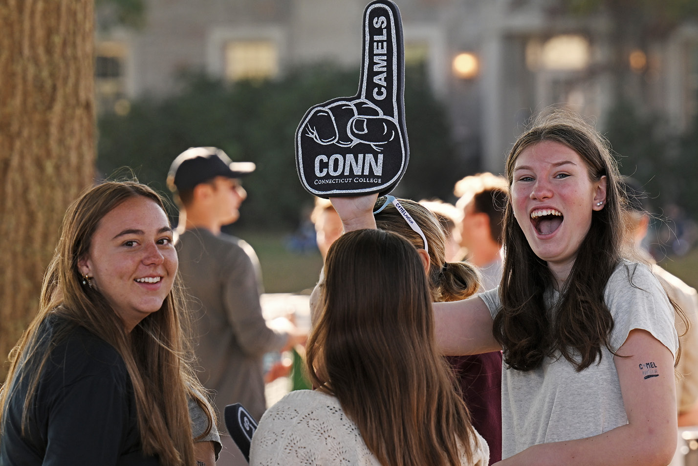 Smiling student holds up a Conn foam prop