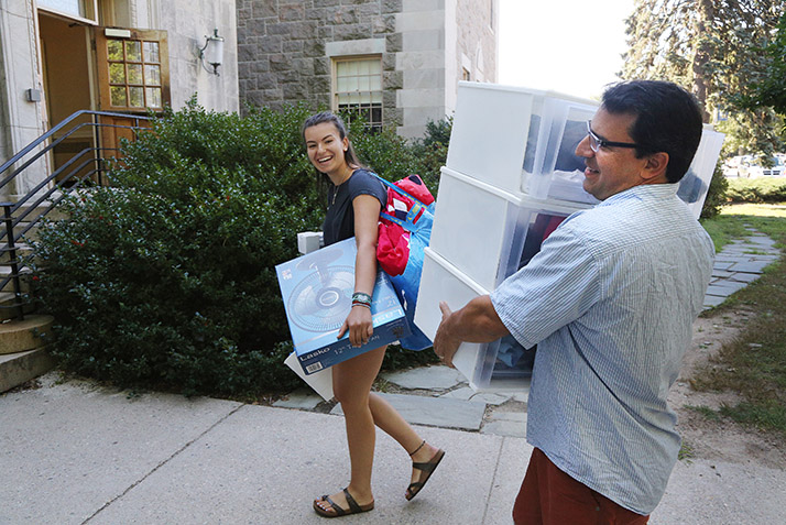 A father helps his daughter move in