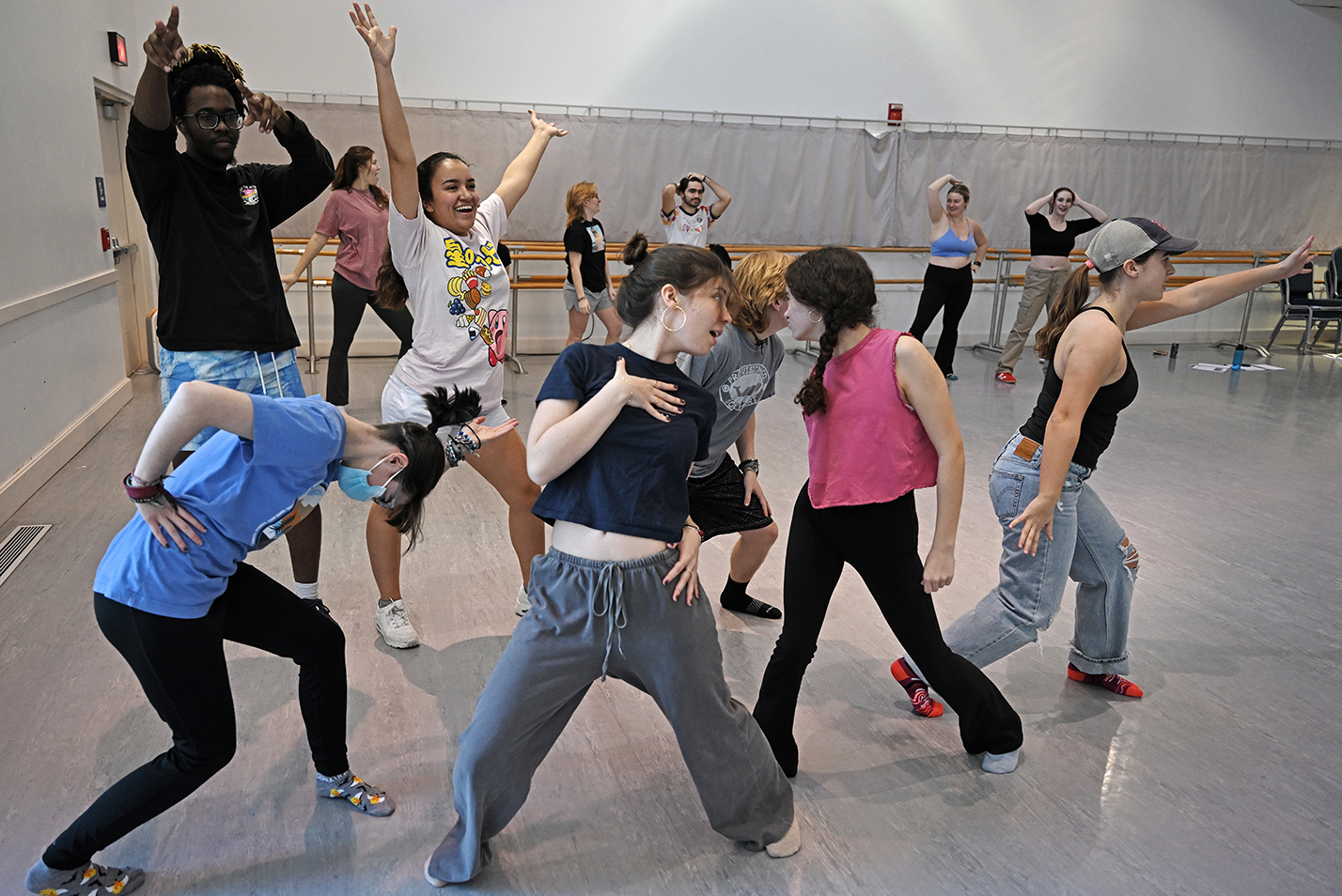 Actors strike poses as they rehearse a dance number for a musical theater production.